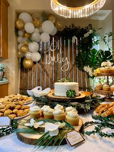 a table topped with lots of cakes and cupcakes