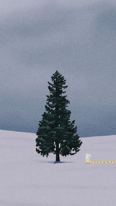 a lone tree in the middle of a snowy field