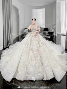 a woman in a wedding dress posing for the camera with her hand on her face