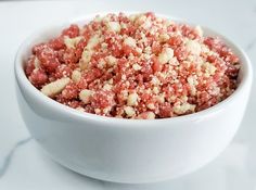 a white bowl filled with food on top of a table