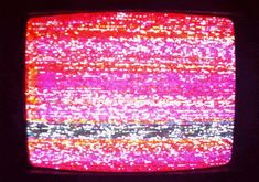 an old television with red and pink colors