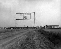 an old black and white photo of a road