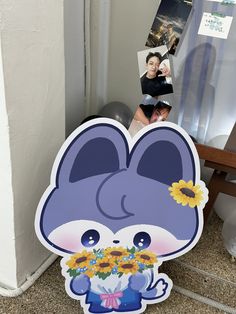 a sticker with an animal holding sunflowers in it's mouth next to a door