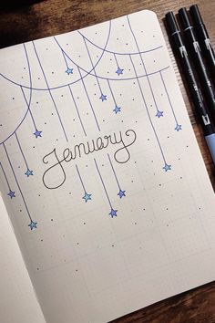 an open notebook with the word january written in cursive writing and stars on it