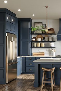 a kitchen with blue cabinets and wooden floors