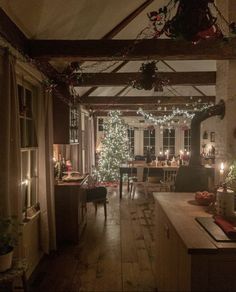 a living room filled with furniture and a christmas tree