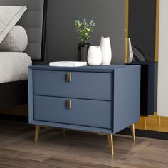 a night stand with two drawers and a vase on it in front of a bed