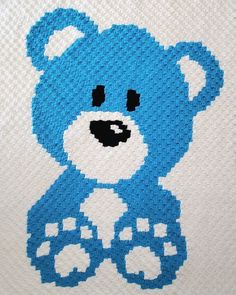 a blue teddy bear made out of legos on a white sheet with black dots