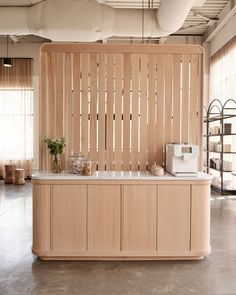 an office with wooden slats on the wall and a counter in front of it