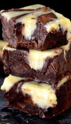 three brownies stacked on top of each other with cheesecake swirl in the middle