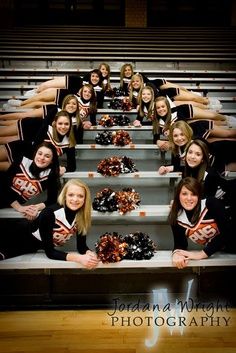 a group of cheerleaders sitting on the bleachers in front of some stairs