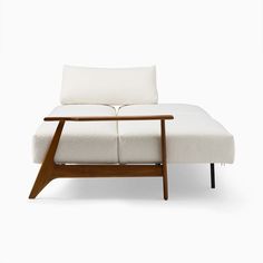 a white couch sitting on top of a wooden frame