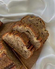 sliced loaf of banana bread sitting on top of a cutting board