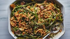 a casserole dish with green beans, mushrooms and other food items in it