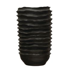 a black vase sitting on top of a white table