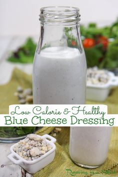 blue cheese dressing in a glass bottle next to a salad