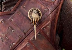 a close up of a person wearing a leather jacket with the words talk to the hand on it