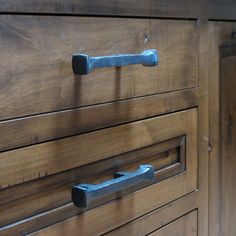 an old wooden dresser with metal handles and knobs