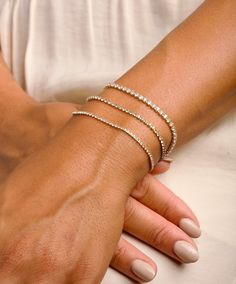 Your favorite Gold Tennis Bracelet, this Diamond Bracelet is dainty and glistens, making it the perfect bracelet(s) for a special occasion as well as everyday wear. We beautifully package every item in a jewelry gift box! Each bracelet is sold individually. * All orders are hand crafted with care from our happy studio in sunny Miami, FL * All items are ethically sourced for durability & perfect finishes * It's not only meant to look beautiful... it's meant to be meaningful * We want you to love Solid Gold Bracelet For Women, Minimalist Stackable Adjustable Tennis Bracelet, Minimalist Adjustable Stackable Tennis Bracelet, Dainty Diamond Bracelet For Party, Delicate Round Bracelets For Party, Dainty Diamond Jubilee Bracelet For Party, Adjustable Dainty Diamond Jubilee Bracelet, Adjustable Dainty Jubilee Diamond Bracelet, Dainty Adjustable Tennis Bracelet With Cubic Zirconia