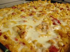 a cheesy casserole with chicken and cheese on it is ready to be eaten