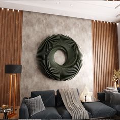 a living room filled with furniture and a large circular metal wall decoration on the wall