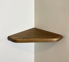 a wooden shelf hanging on the wall