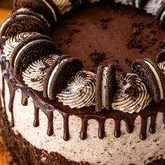 a chocolate cake with oreo cookies and cream frosting drizzled on top