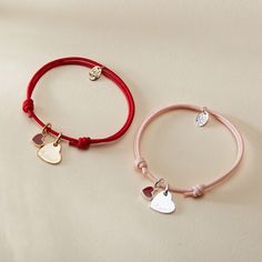 Our Personalized Valentines Heart Bracelet is a sweet symbol of love and affection, perfect for Valentine's Day and beyond. Each bracelet features two charms: a dainty and romantic mini red heart, and a shiny heart charm to hand-engrave with the name of a true love. Both charms move freely along your choice of colorful braid.18K Champagne Gold Plated or 925 Sterling SilverHeart: 0.4x 0.4Mini Red Lacquer Heart: 0.25 x 0.21Braid made of a durable, colourfast polyesterFully adjustable sliding knot Adjustable Heart-shaped Sterling Silver Name Bracelet, Adjustable Sterling Silver Heart Name Bracelet, Adjustable Double Heart Bracelet, Valentine's Day Heart Charm Bracelet With Heart Pendant, Friendship Bracelets With Double Heart Charm, Valentine's Day Adjustable Name Bracelet With Heart Charm, Adjustable Name Bracelet With Heart Charm For Valentine's Day, Valentine's Day Double Heart Adjustable Charm Bracelet, Adjustable Heart Charm Name Bracelet For Valentine's Day