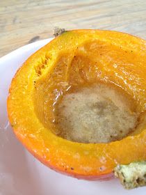 a white plate topped with a cut in half pumpkin