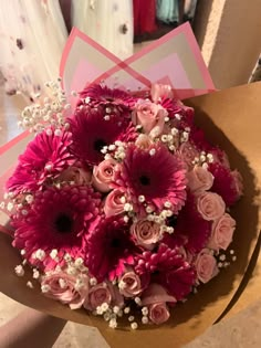 a bouquet of pink and white flowers in a box