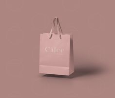 a pink shopping bag with the word calee on it's front and side