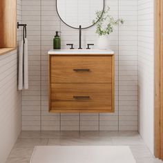 a bathroom with a sink, mirror and rug on the floor in front of it