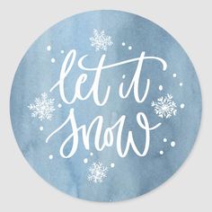 the let it snow sticker is shown in white lettering on blue watercolor paper