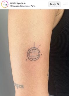 a woman's arm with a tattoo on it that has a globe in the middle