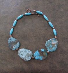 Turquoise, howlite stone, and copper necklace.  Toggle clasp. 18 inches long Artisan Turquoise Multi-stone Necklace, Unique Blue Multi-stone Turquoise Necklace, Hand-strung Blue Turquoise Necklace, Bohemian Turquoise Multi-stone Necklace, Luxury Artisan Multi-stone Turquoise Necklace, Turquoise Statement Necklace, Howlite Stone, Copper Necklace, Toggle Clasp