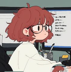 a woman with glasses sitting at a desk in front of a computer