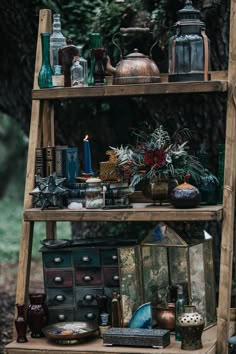 an old wooden shelf filled with lots of antiques