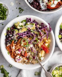 two white bowls filled with different types of food and garnished with avocado