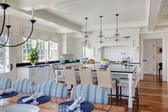 a dining room table with blue and white chairs