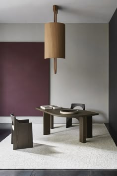 a wooden table sitting on top of a white rug