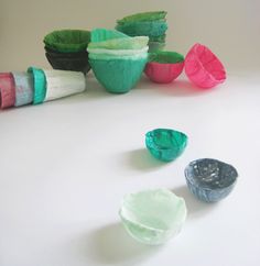 three different colored bowls sitting next to each other on a white counter top, with one empty bowl in the middle