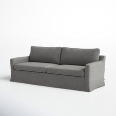 a gray couch sitting on top of a white floor