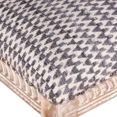 an upholstered wooden bench with grey and white checkered fabric on the seat