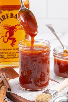 a spoon full of honey sitting on top of a jar