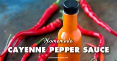 homemade cayenne pepper sauce in a glass bottle surrounded by red hot chili peppers