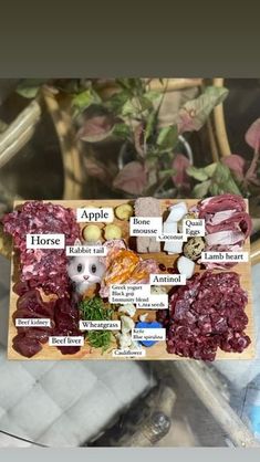 an assortment of meats and vegetables on a cutting board