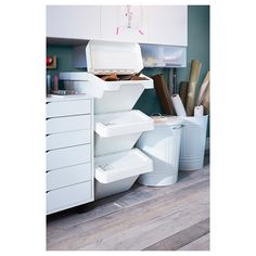 a kitchen with white cabinets and lots of utensils