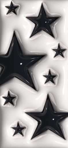 black and white stars are arranged in the shape of an abstract pattern on a surface