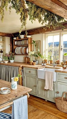 a kitchen filled with lots of counter top space and wooden flooring next to a window