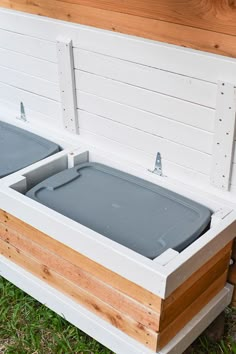 an outdoor bench with two storage bins on it